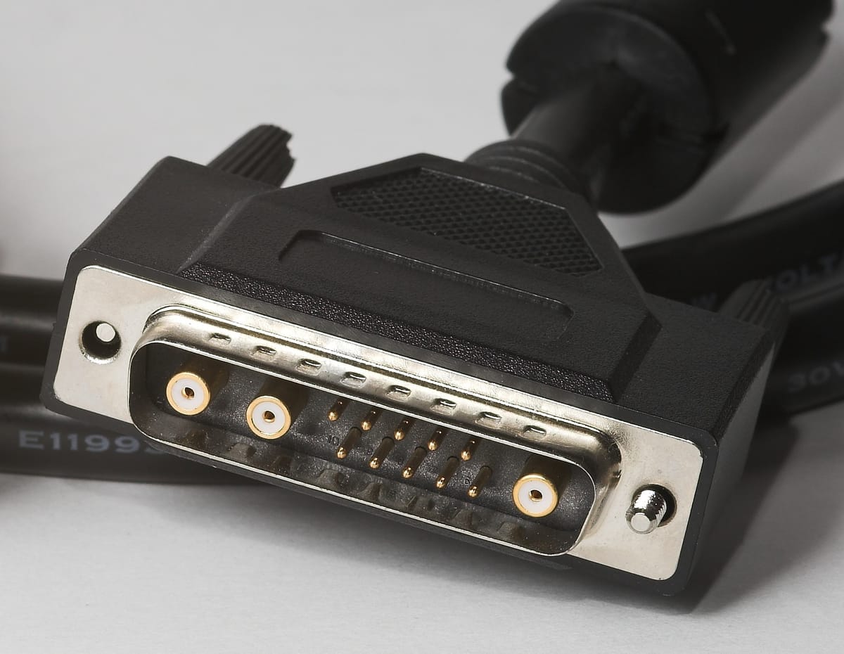 A photo of a 13W3 connector featuring 13 pins and three coax connectors in a DB-series shell